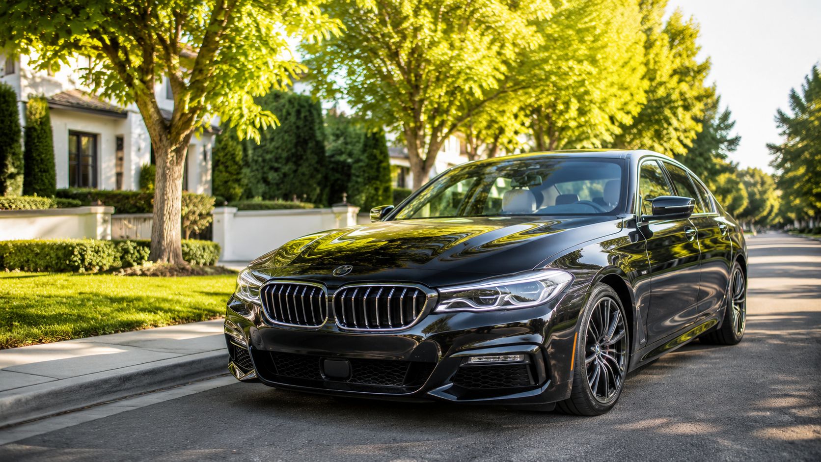 A luxurious black BMW sedan parked on a quiet residential street lined with green trees.
