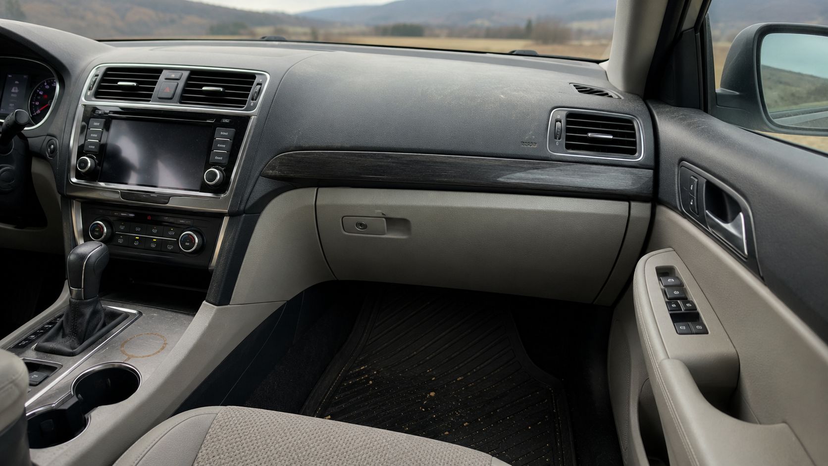 A view of the interior cabin and dashboard of a modern car showing passenger seat area.