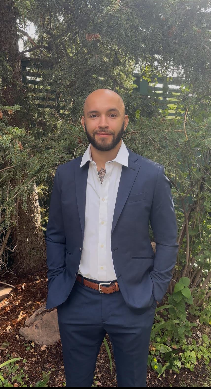 Founder of Generational Growth standing outdoors in navy suit — financial strategist and educator helping clients master Infinite Banking and wealth-building systems