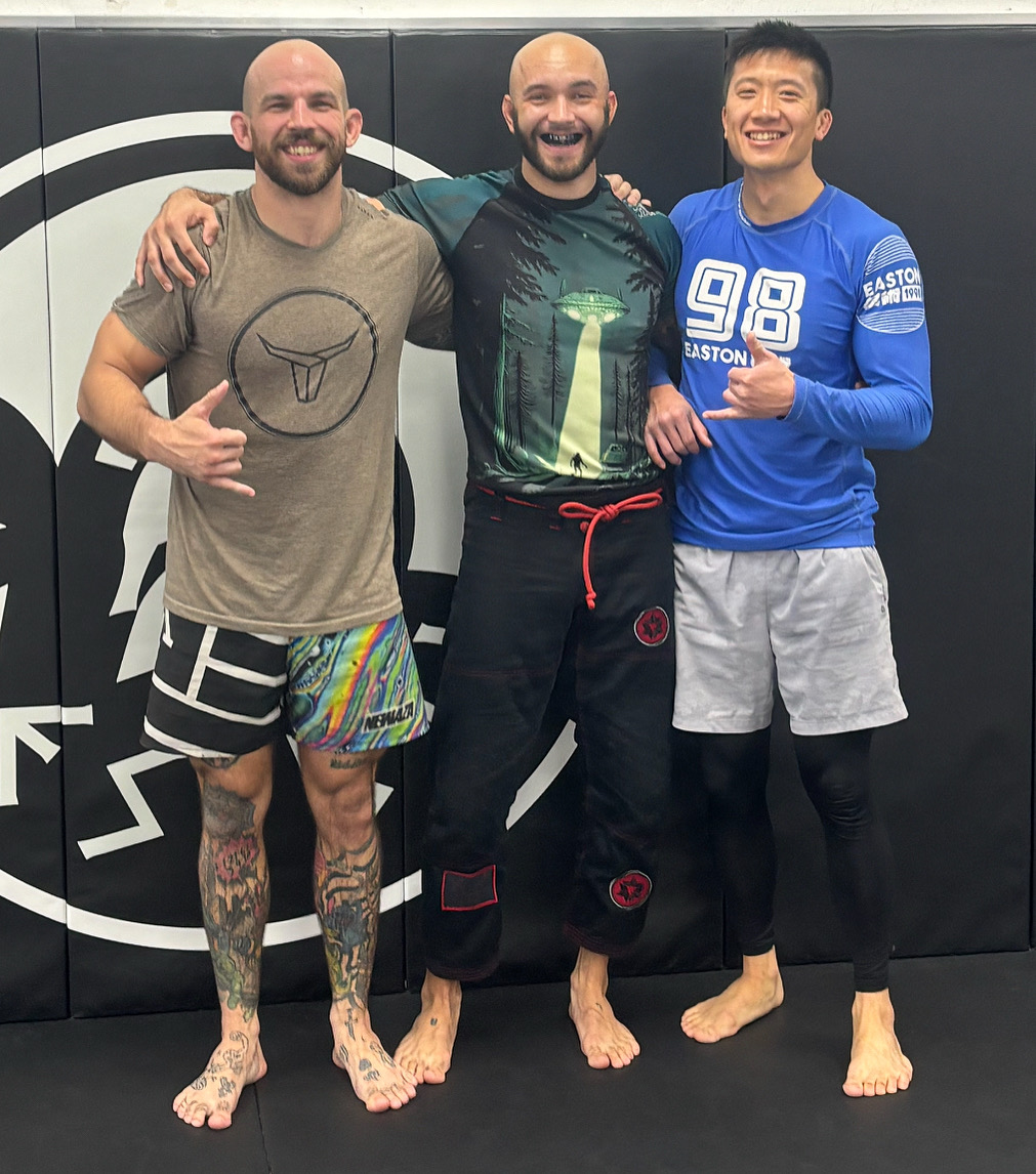 Generational Growth founder presenting a financial donation to a youth martial arts student, representing community giving and purpose-driven wealth