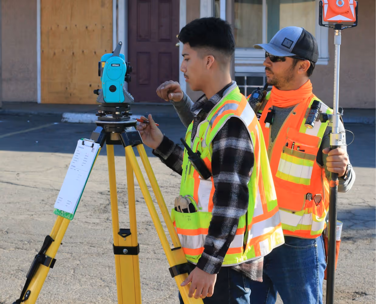 Surveyors operating survey equipment