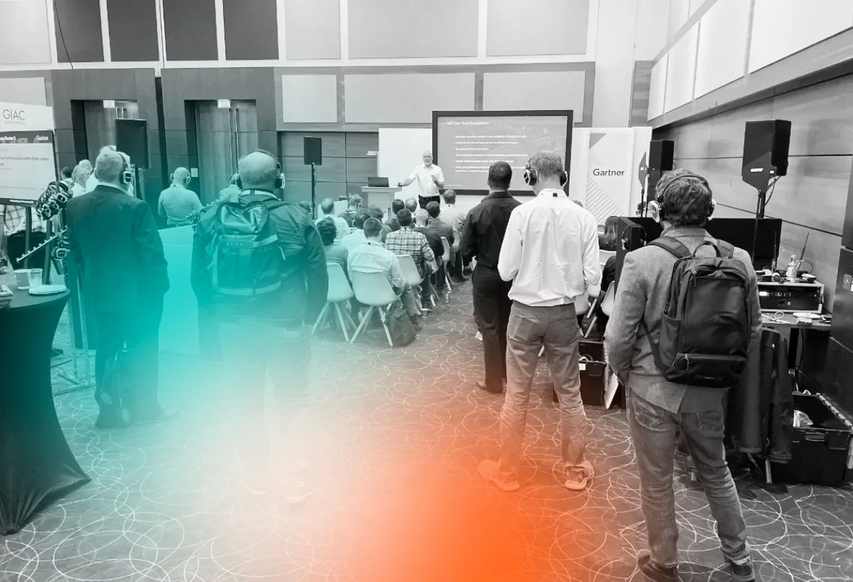 Illumio presenting to a diverse crowd in multiple languages.