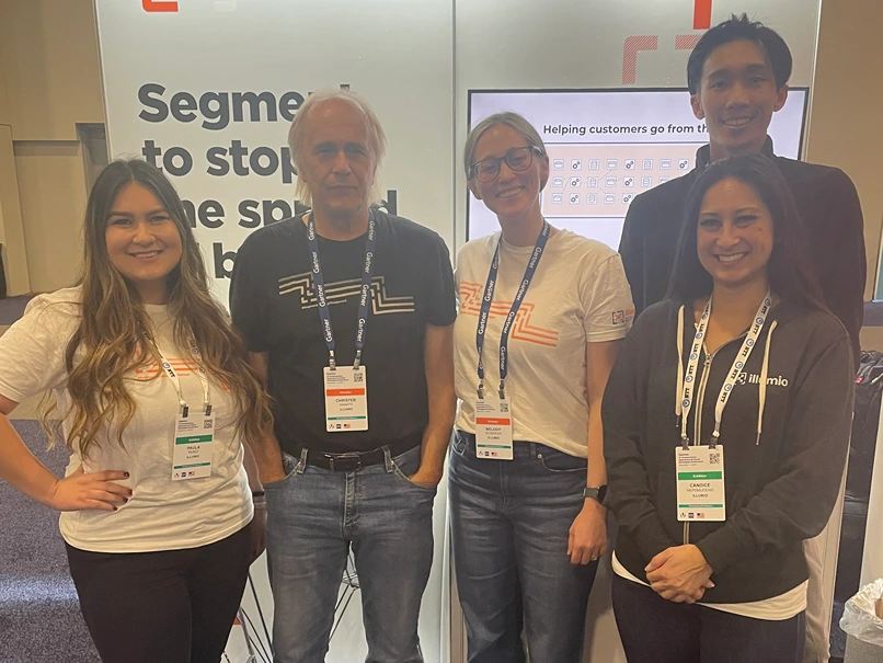 Smiling representatives from Illumio and other companies taking a photo together at a convention.