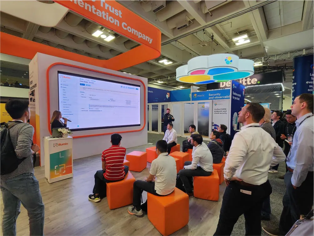 Cybersecurity professionals watching an Illumio ZTS Platform demo at an event