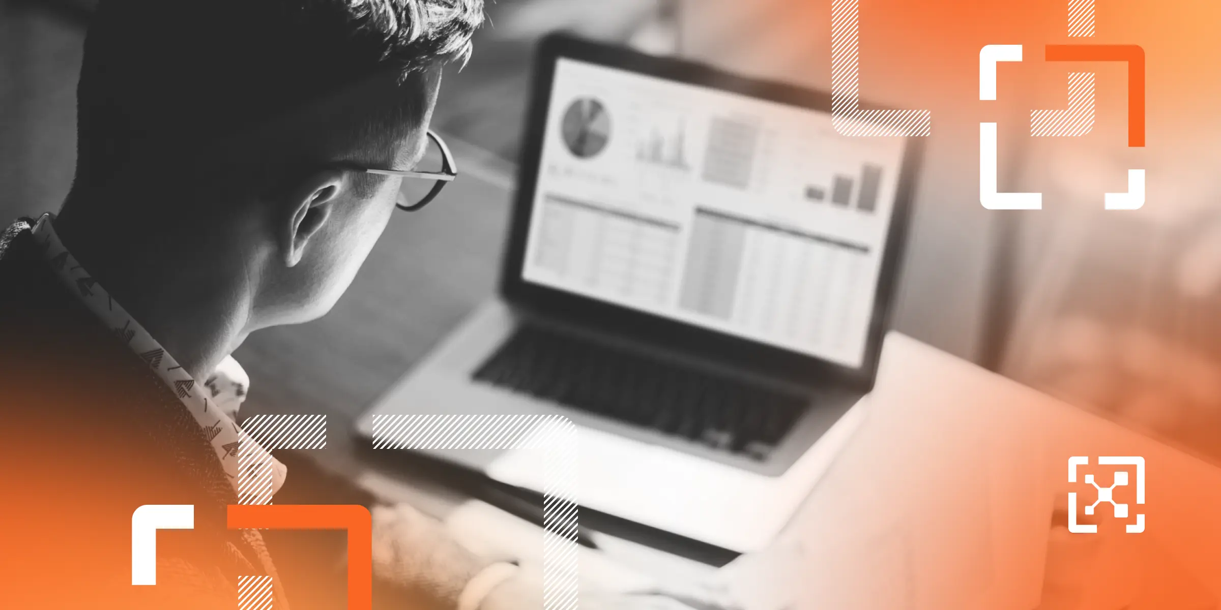 Black and white banking professional looking at data on a laptop