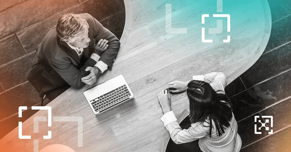 Two black and white cybersecurity professionals discussing business ROI