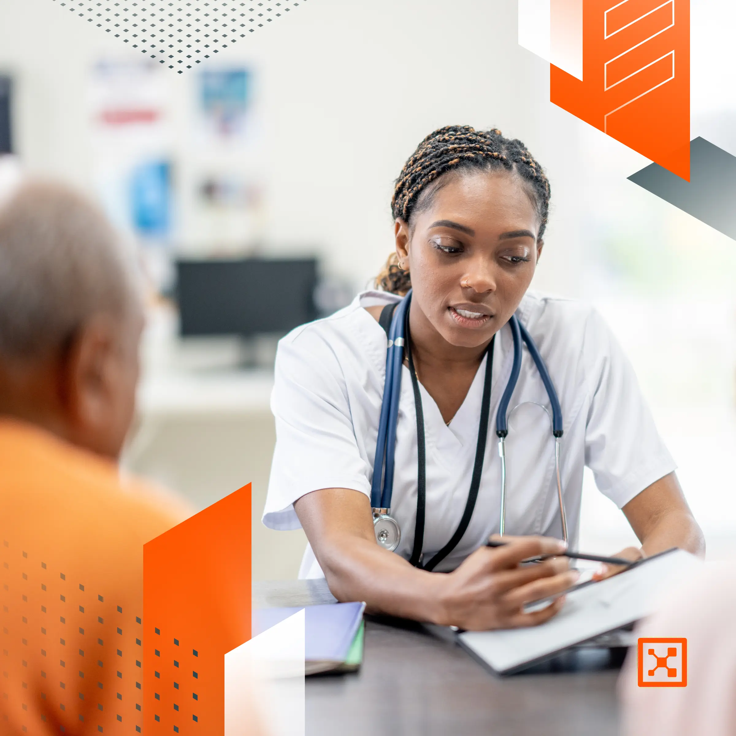 A healthcare professional with a stethoscope discusses information on a tablet with an elderly patient in a medical office