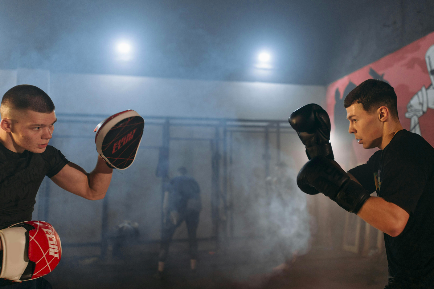 Two men training in striking with punching and boxing gloves