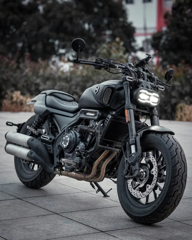 Voge CU525 motorcycle in a studio with dramatic lighting, front-side angle.