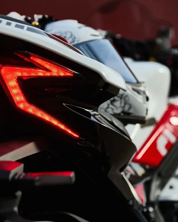 Rider leaning into a corner on a red VOGE RR660S sport motorcycle.