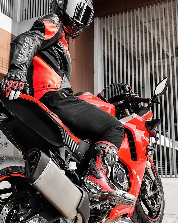 Side view of a red VOGE 525RR motorcycle with rider in gear, highlighting sporty styling.