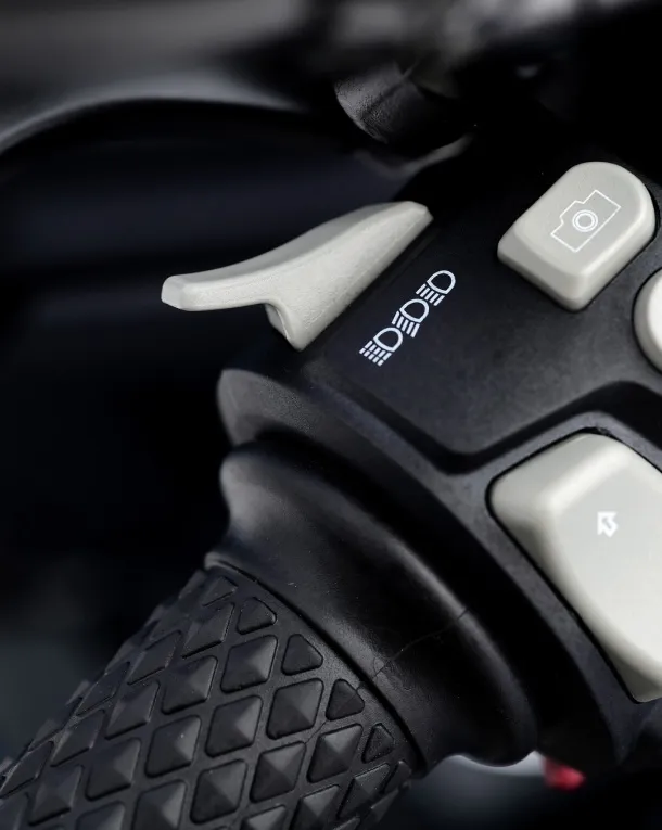 Close-up shot of the Voge 525R handlebar and controls, showcasing the grip and switchgear details.