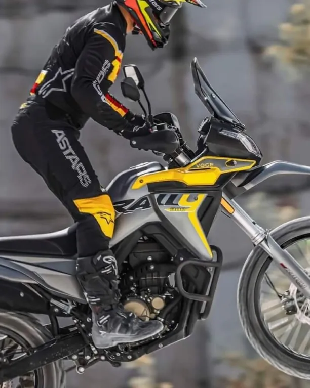Side view of Voge 300 Rally in black and yellow during a showcase event.