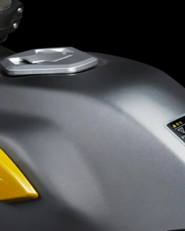 Close-up of the Voge 300 Rally fuel tank in matte silver with yellow accents.