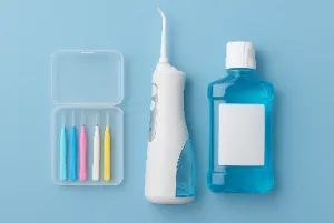 An image of intradental brushes, water floss, and mouthwash.
