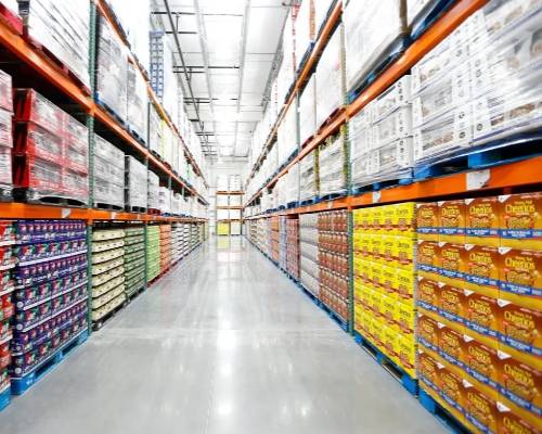 Warehouse aisle with colorful shelves stocked with various packaged goods