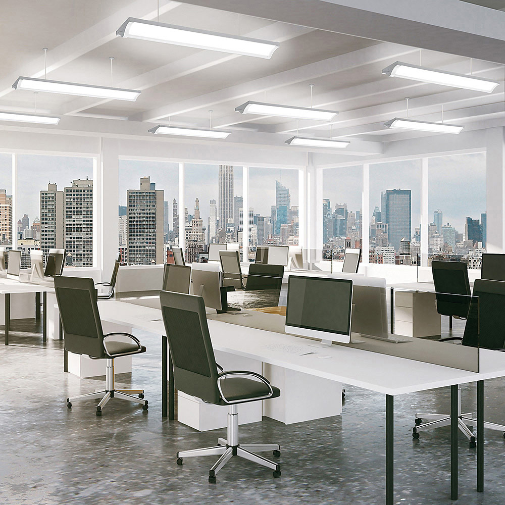 Modern office interior with city skyline, empty workstations and large windows