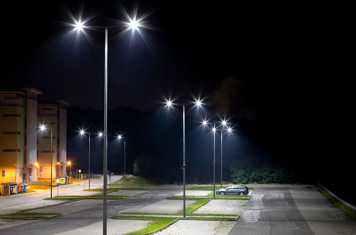 Night view of illuminated street with streetlights and parked car