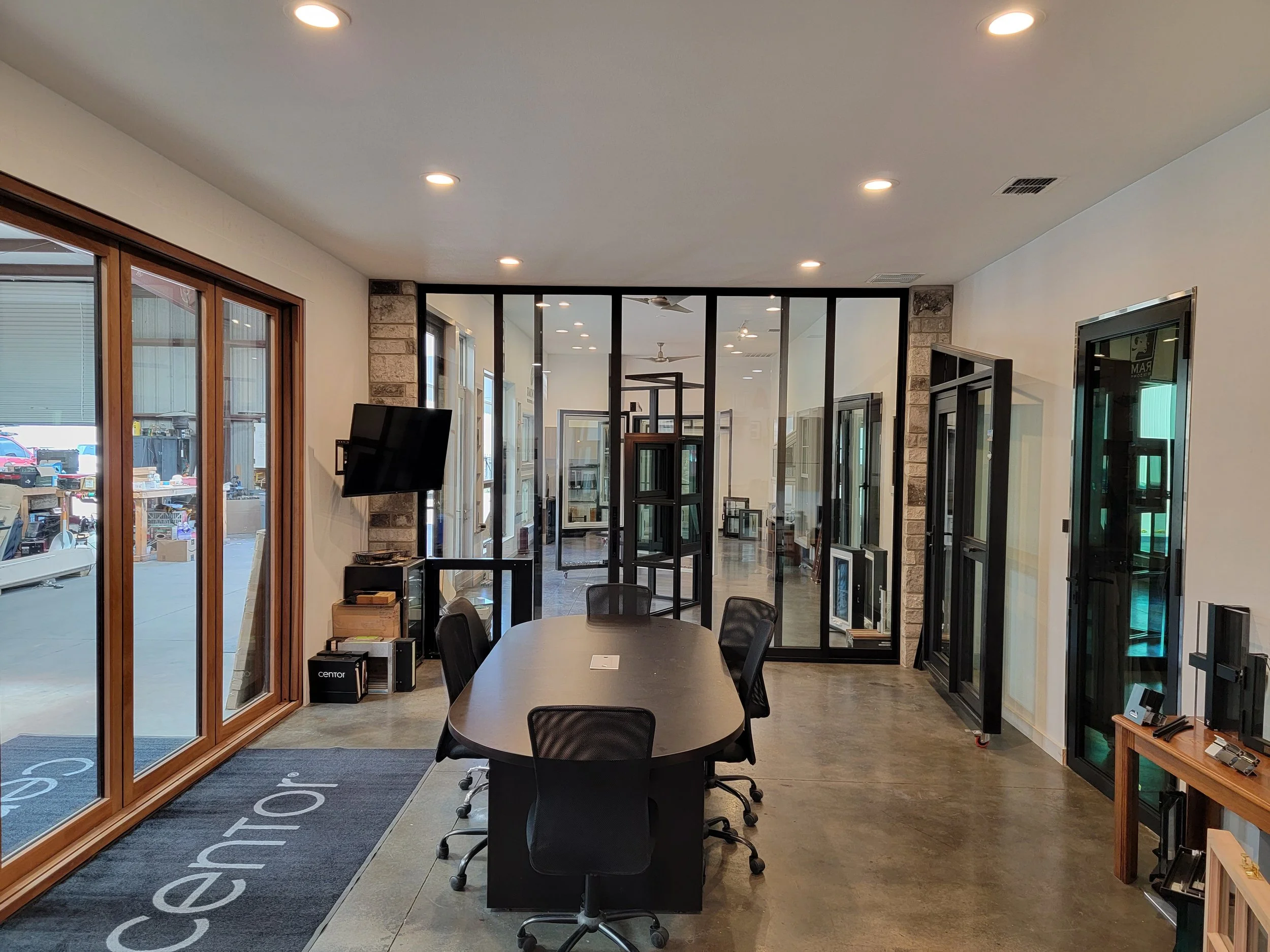 Modern conference room with glass walls and black conference table