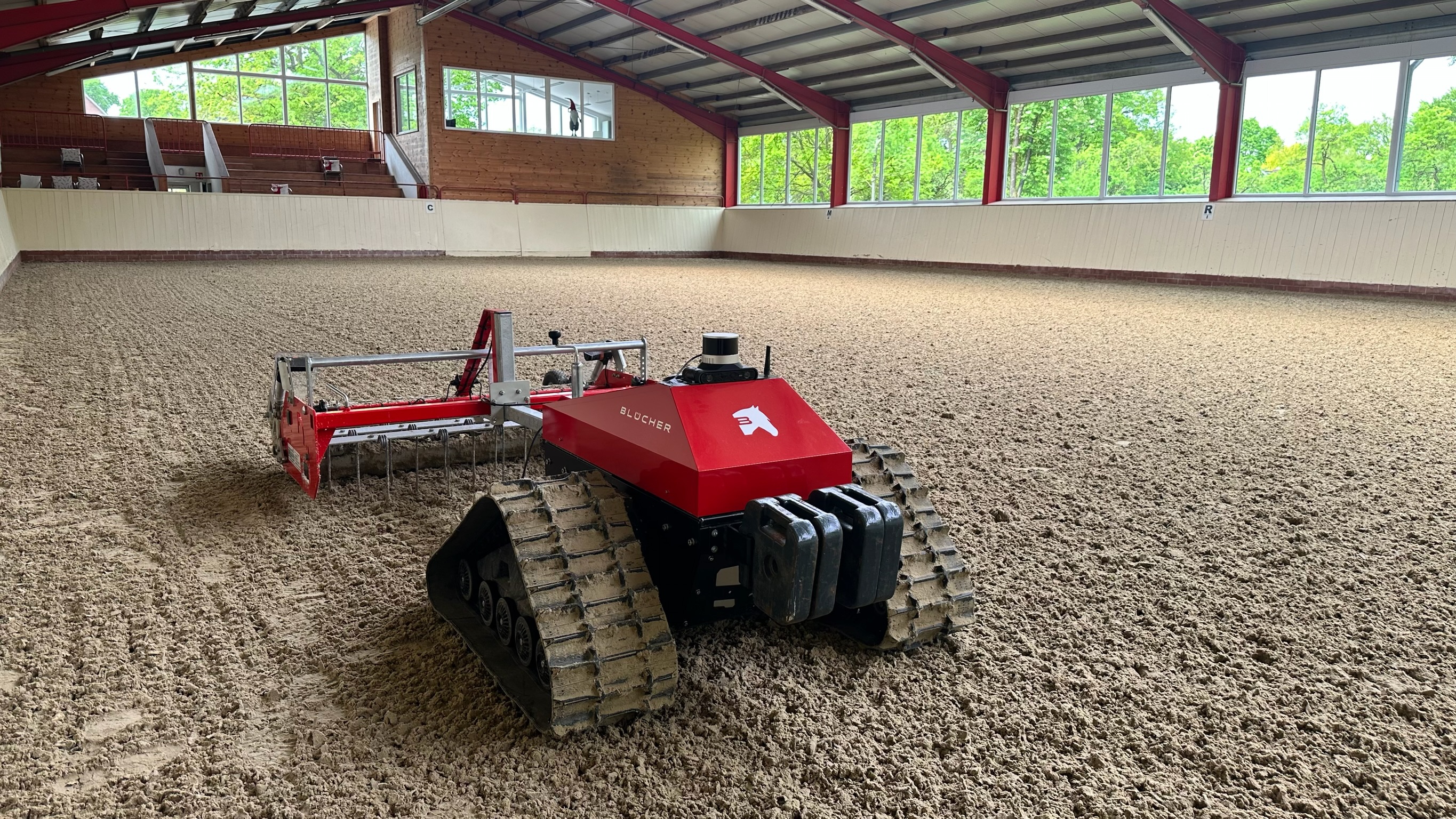 Blücher robot grooming a riding arena