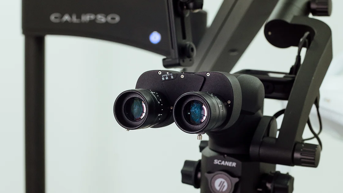 A close up of a camera on a tripod.