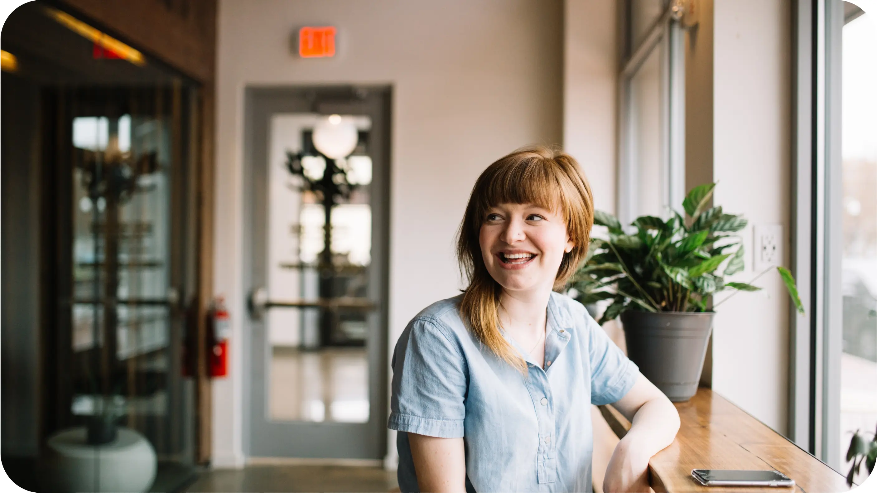 Woman smiling on a desk 
