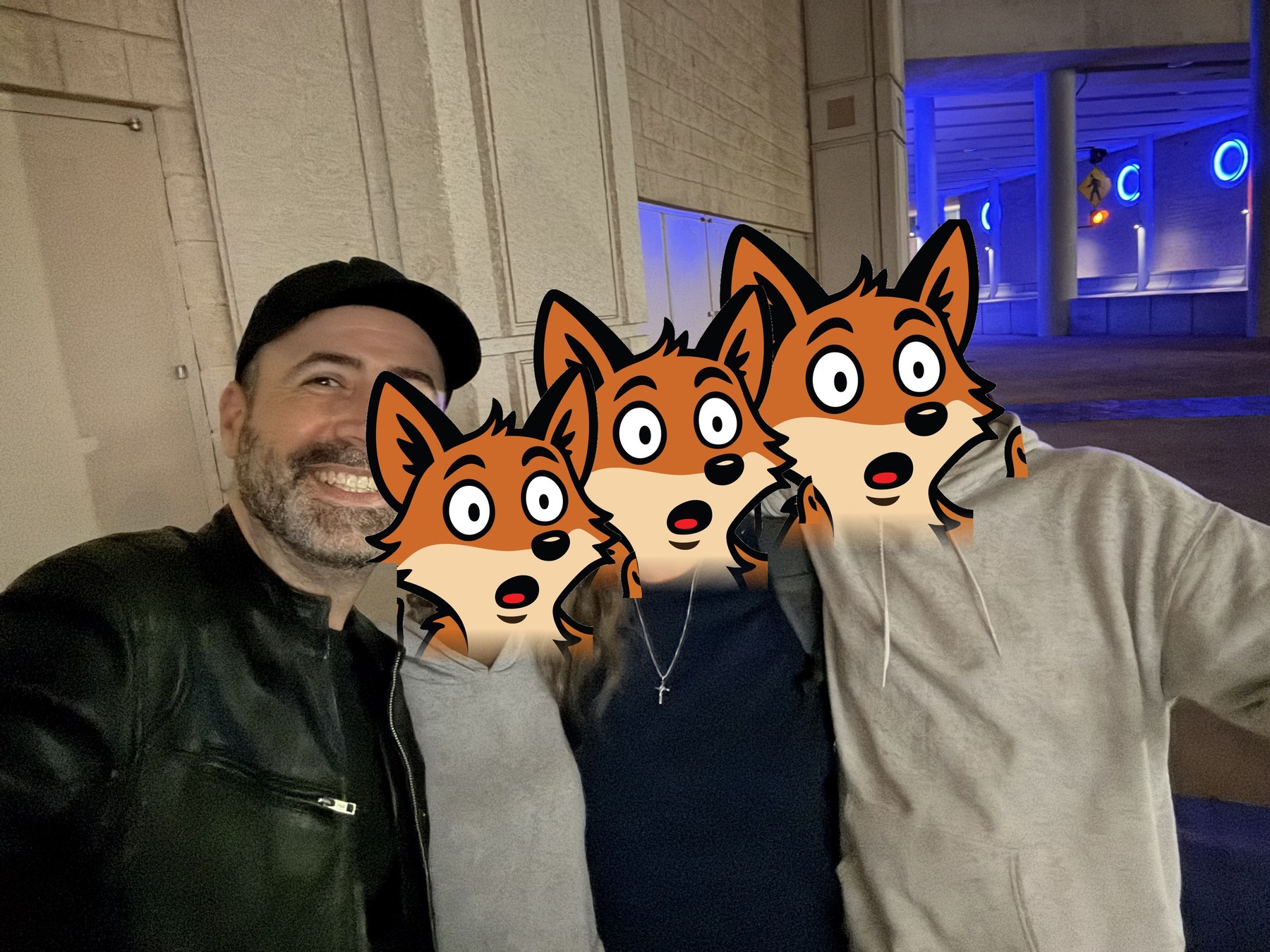 Justin with three friends outside the Tampa Convention Center at night, their faces covered by the Cray fox