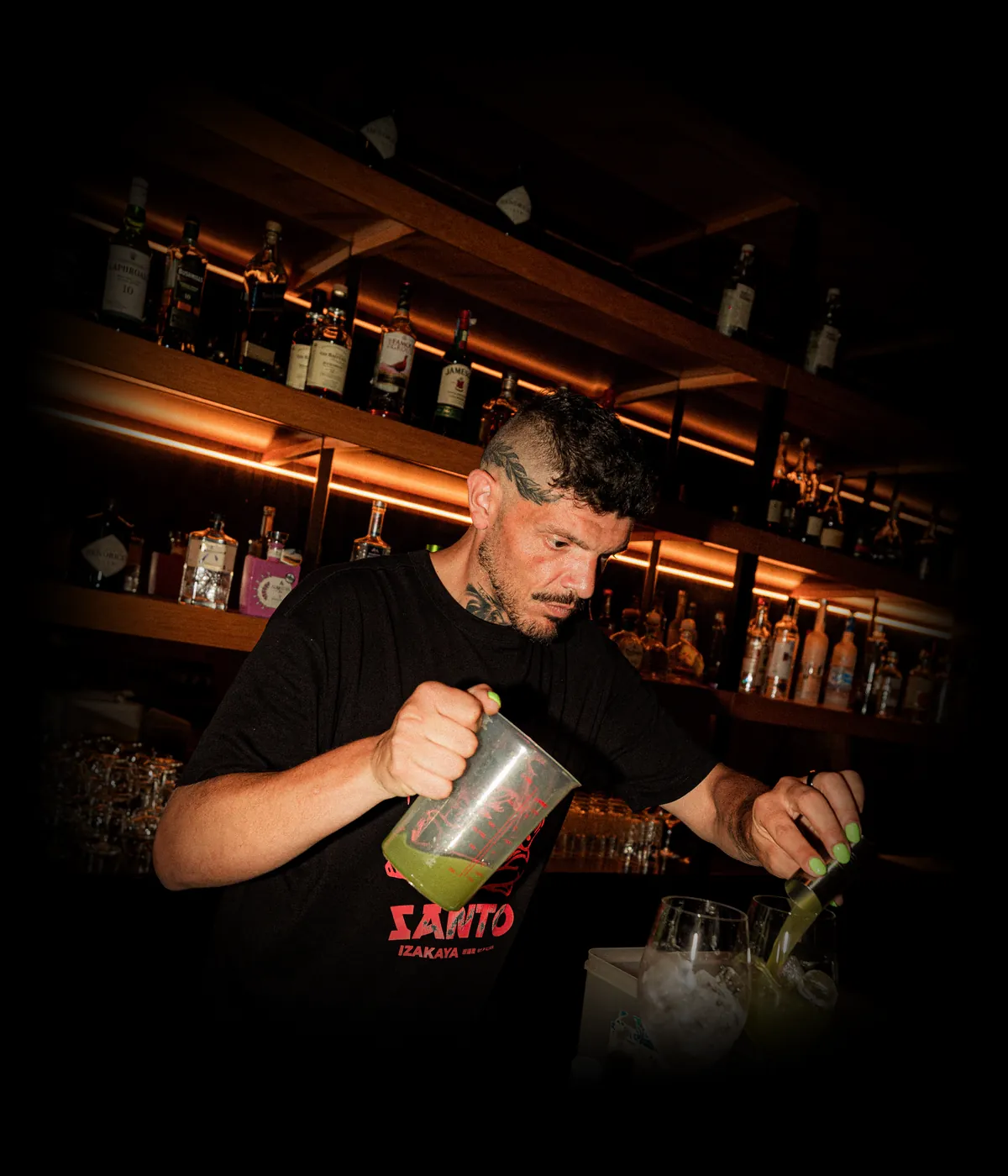 Prato do Santo Izakaya servido na mesa escura, com pintura ao fundo