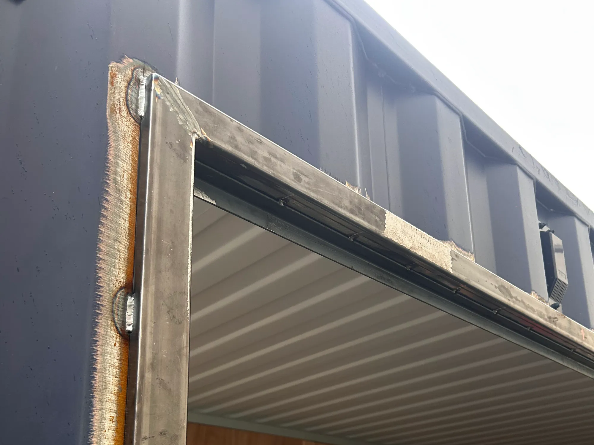 Converting a shipping container into a functioning drinks bar at the St.Johnstone Football Club fanzone by installing two hinged serving hatches.