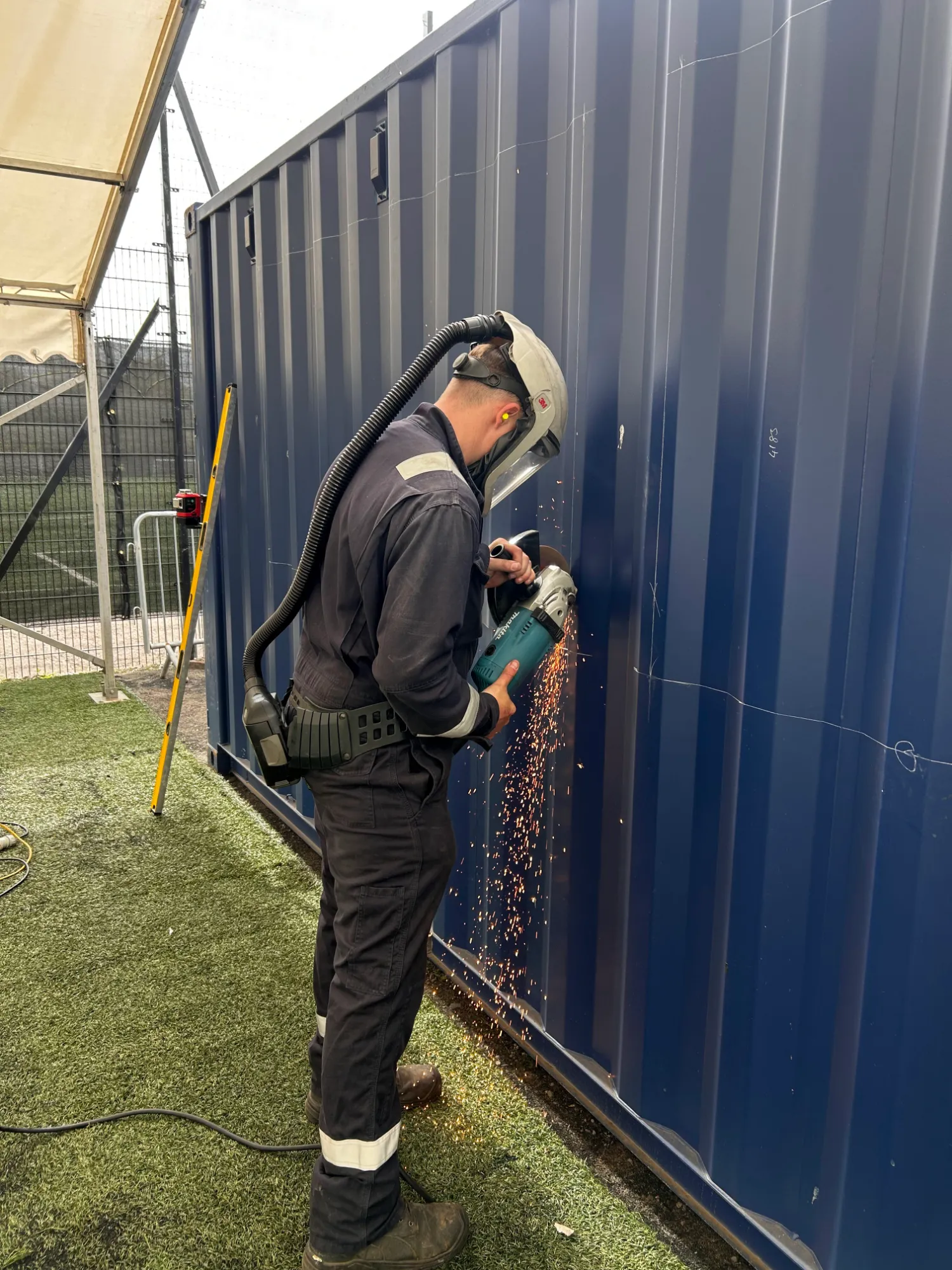 Converting a shipping container into a functioning drinks bar at the St.Johnstone Football Club fanzone by installing two hinged serving hatches.