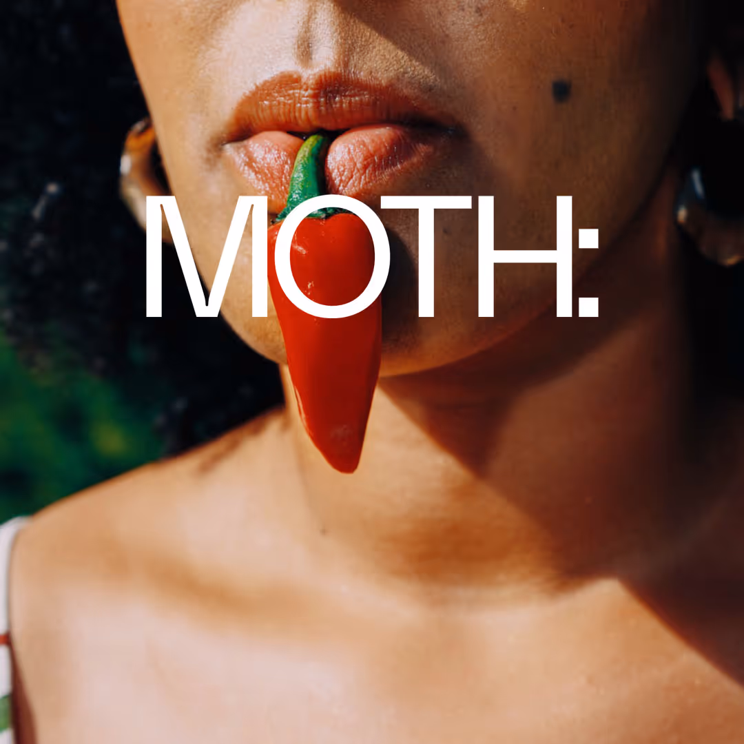 Close-up of a person holding a red chili pepper between their lips with the word 'MOTH:' overlayed.