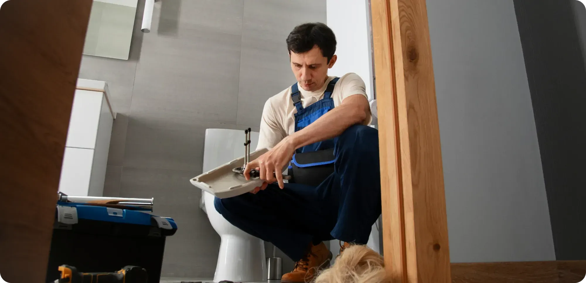 A plumber who is fixing the toilet clogging 