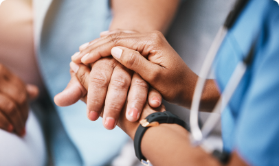 A diverse group of professionals' hands are stacked together in the center of a circle, symbolizing teamwork and collaboration.