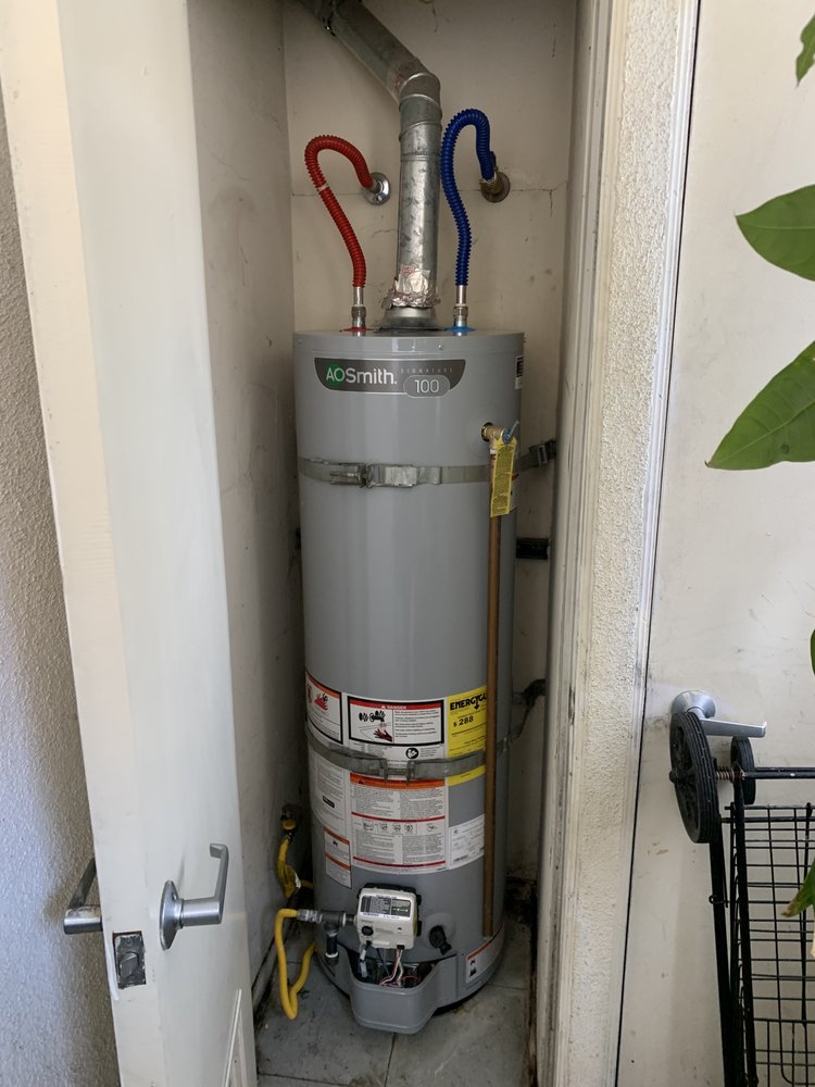 Tall water heater installed in a small closet space.