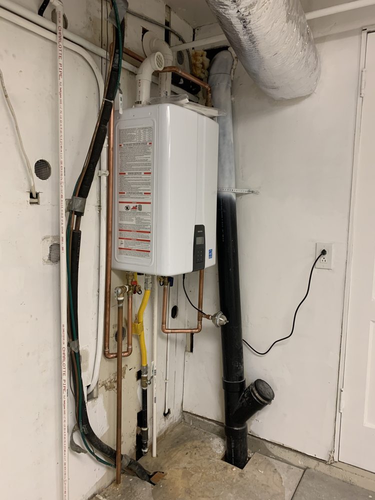 Tankless water heater installed with copper piping and venting.