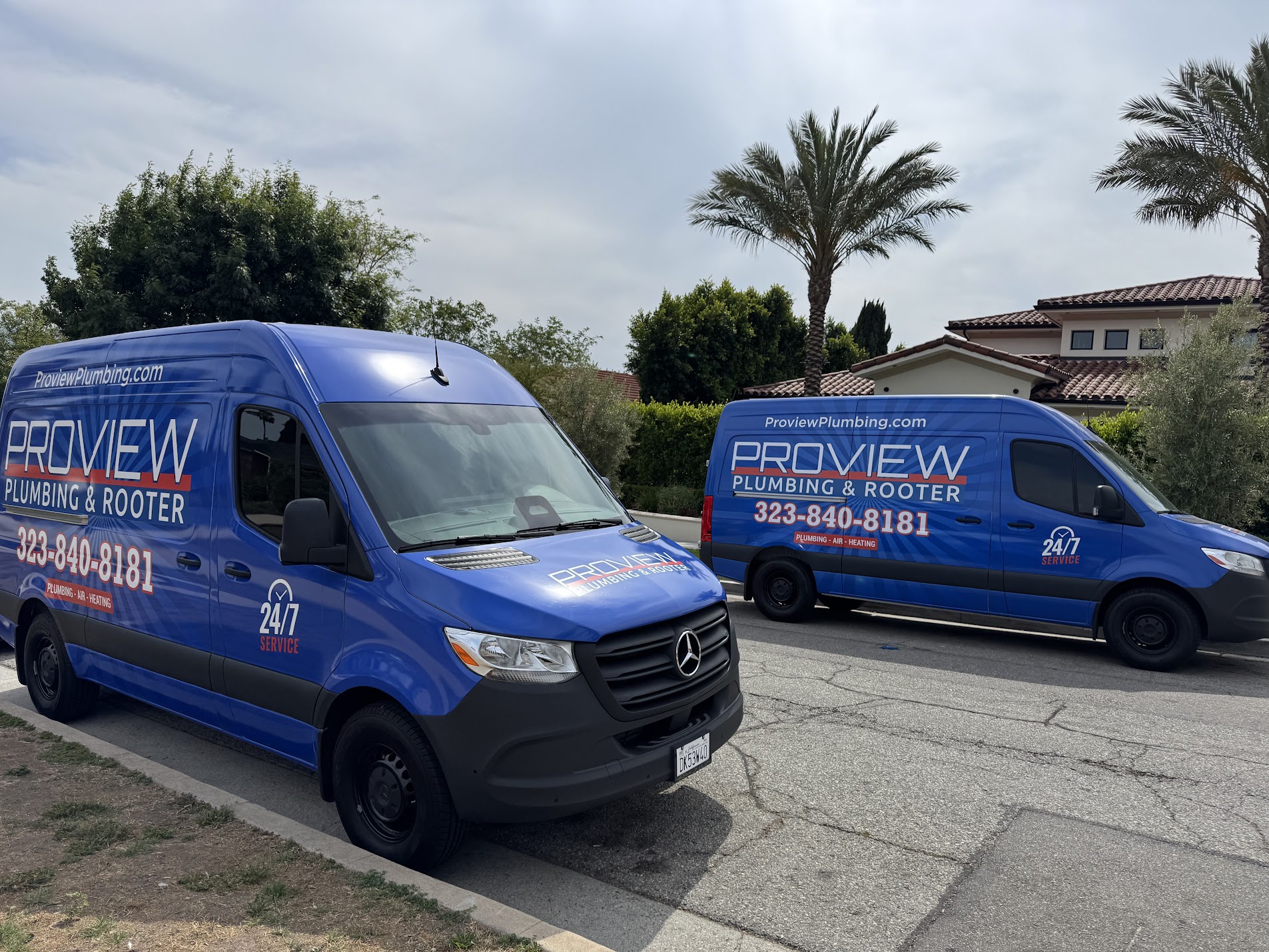ProView Plumbing & Rooter service vans parked on a residential street for heat pump installation in Pasadena CA.