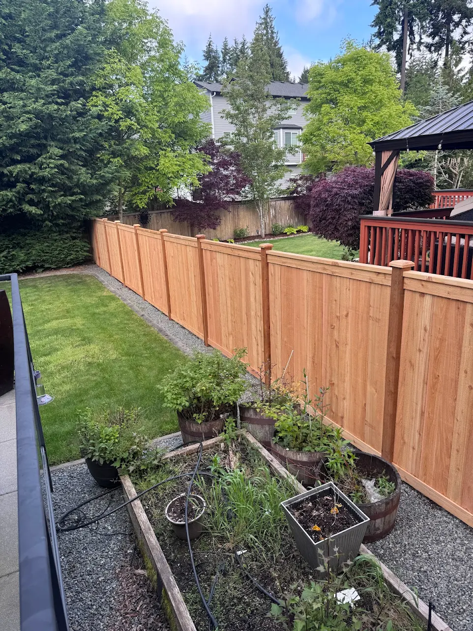 New cedar privacy fence installed along a residential backyard
