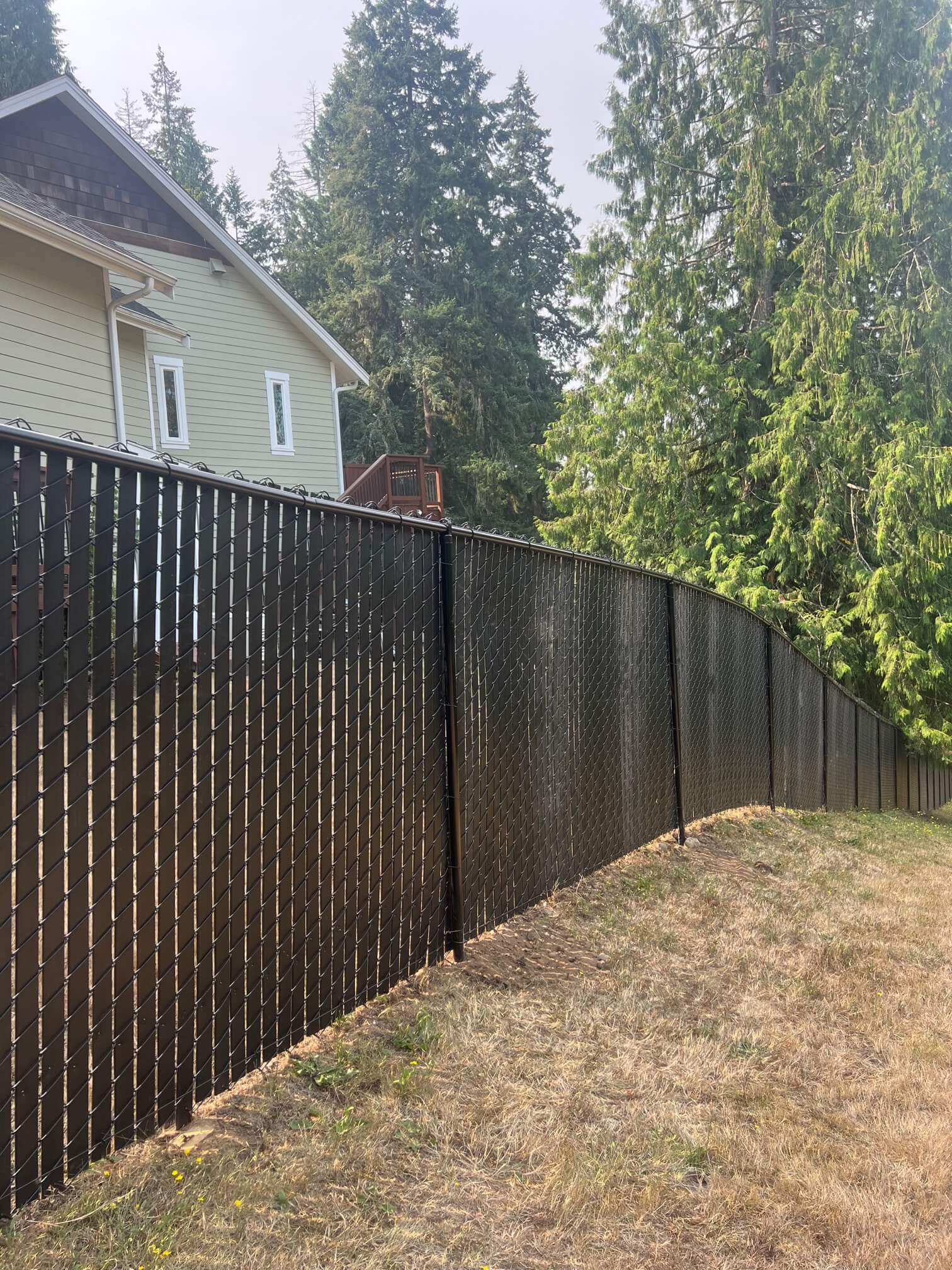 Sloped installation of black chain link with vertical