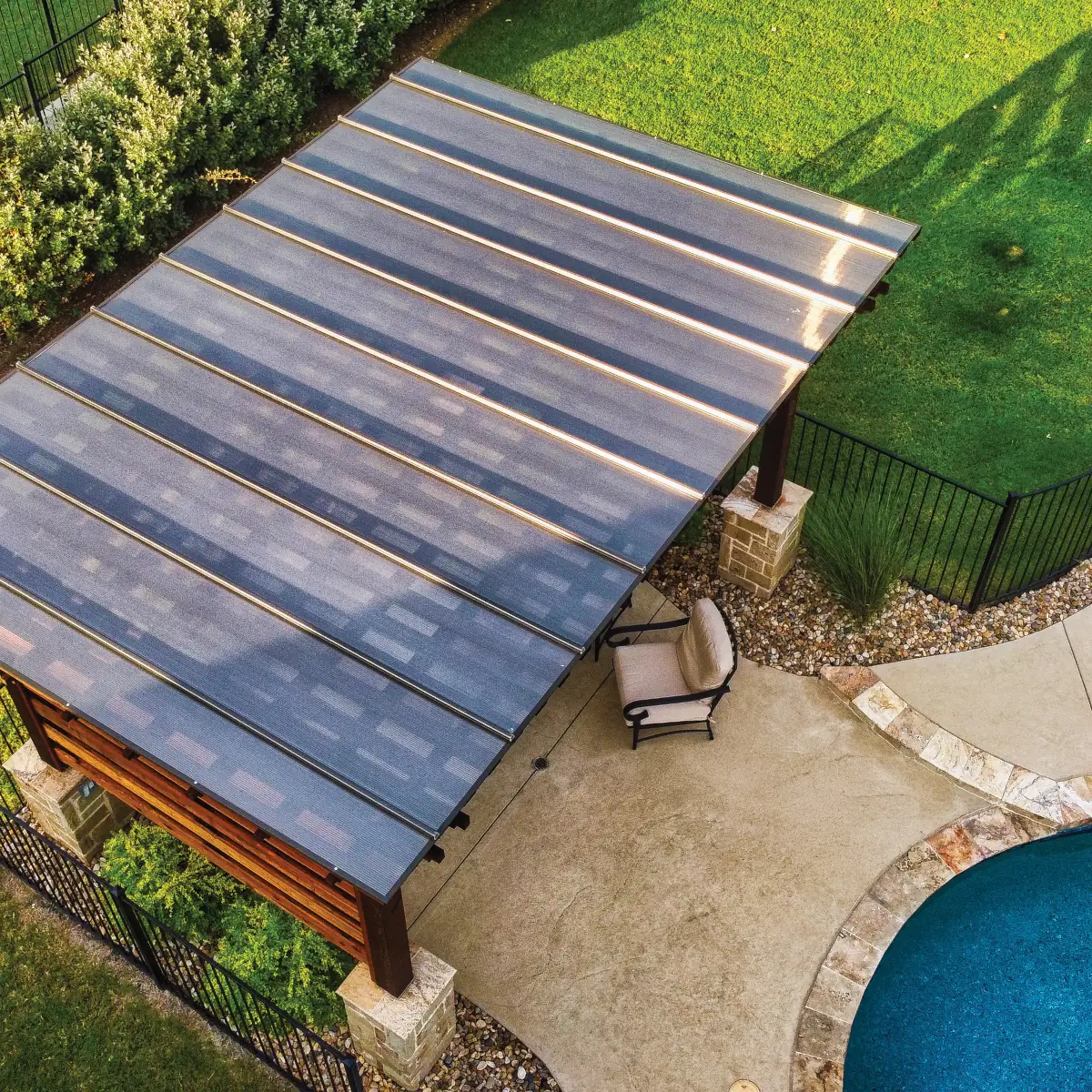 WeatherShield pergola cover installation with clear polycarbonate panels on a backyard pergola attached