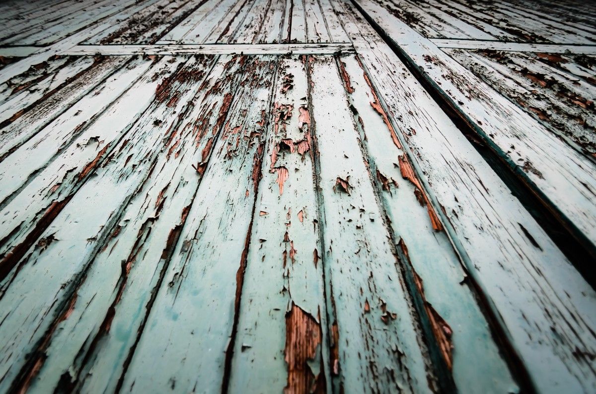 Damaged deck in Seattle with pealing paint due to long rains
