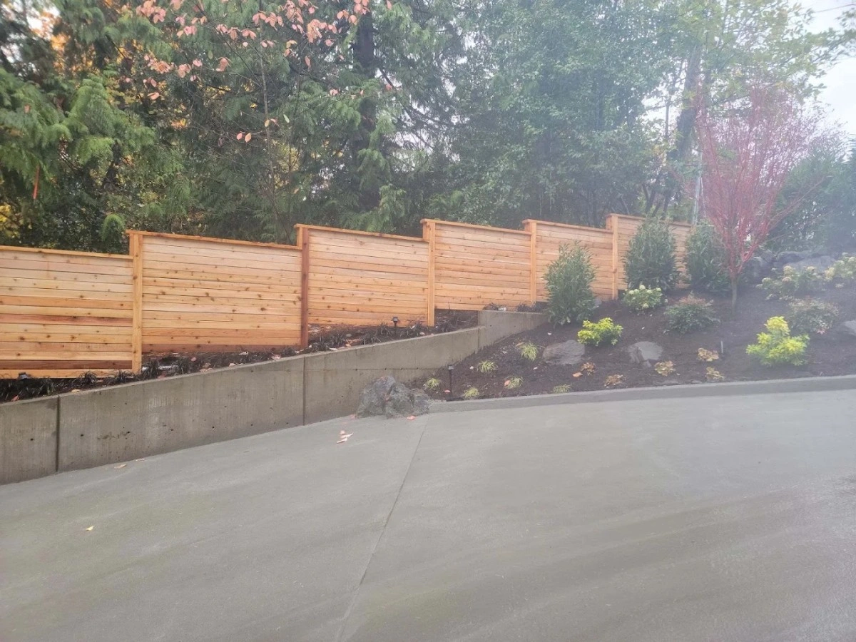 Cedar fence panels installed near a sloped driveway in Greater Seattle