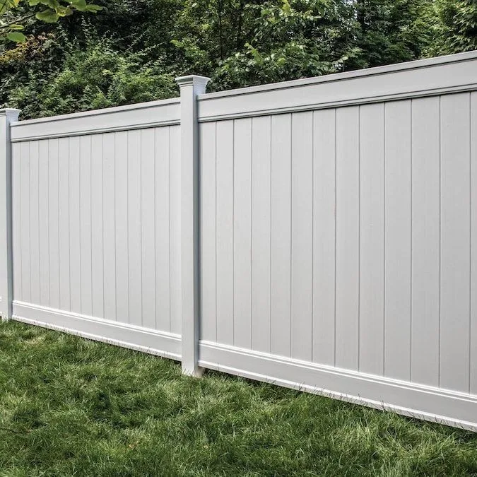 Gray vinyl privacy fence enclosing a Seattle backyard with solid panels