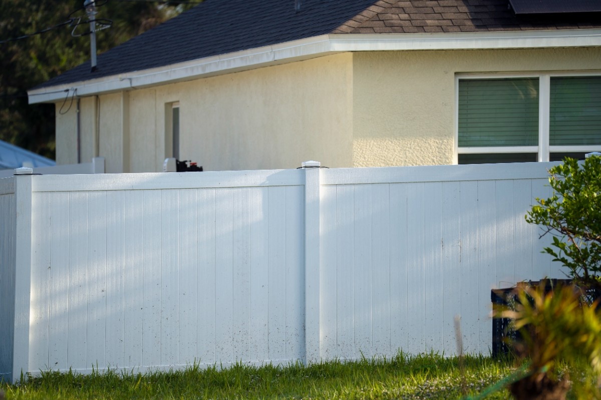 Six-foot white vinyl privacy fence securing a Seattle home's backyard