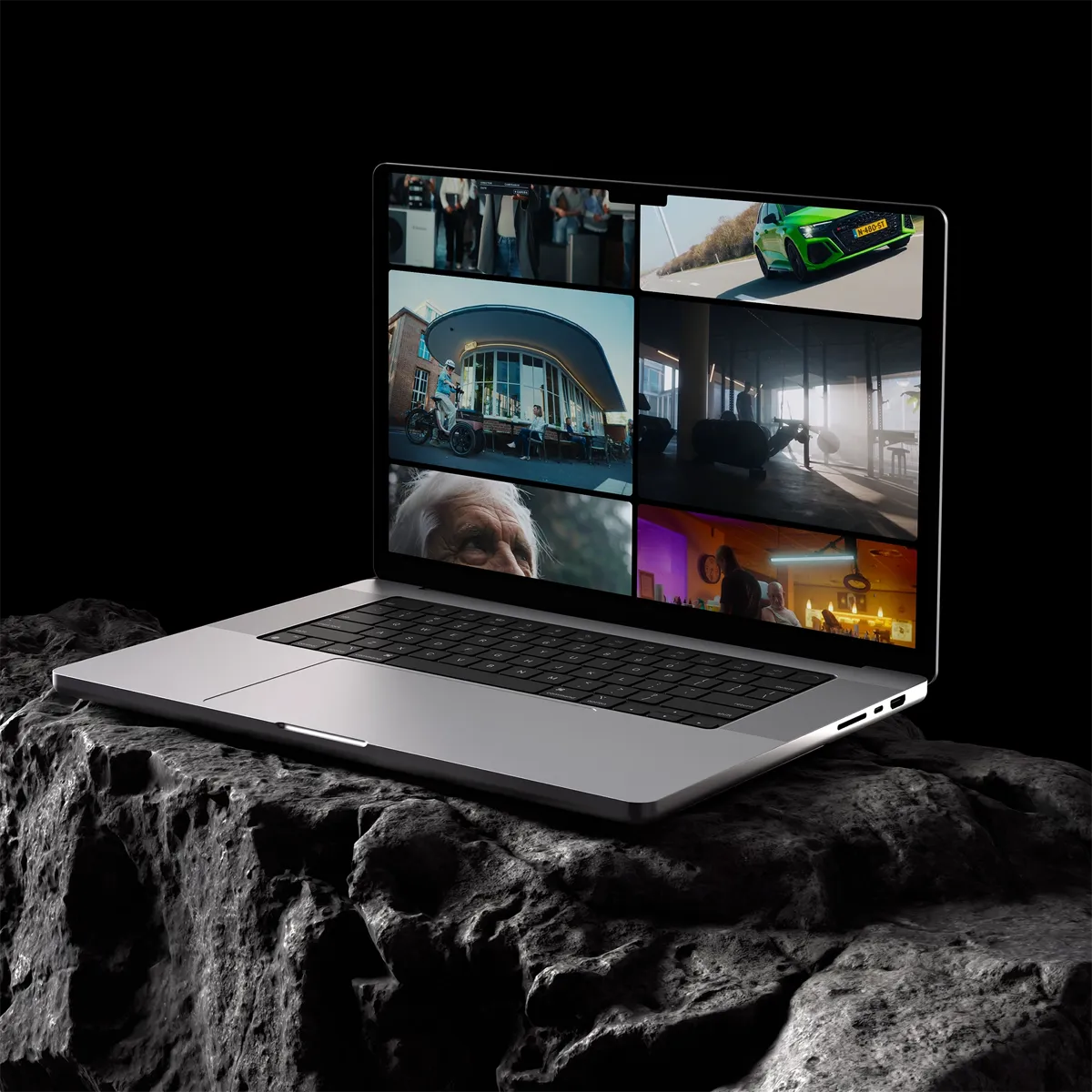 Laptop op donkere rots met portfolio website waarop verschillende videoprojecten worden getoond, ontworpen door East Creatives.