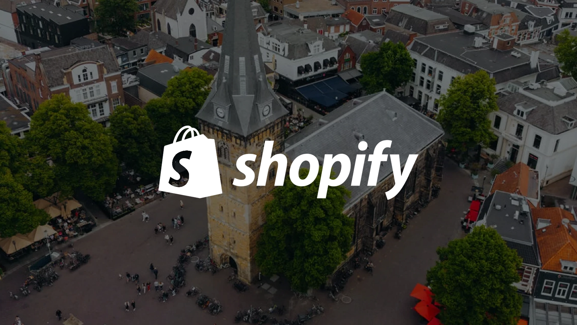 Het Shopify-logo over een luchtfoto van de Oude Markt in Enschede, bij het artikel over lokale webshops bouwen met Shopify