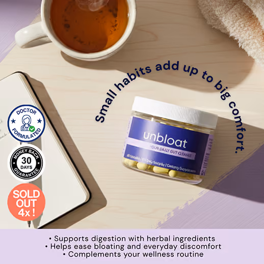 Unbloat supplement jar on a desk with tea and a notebook.
