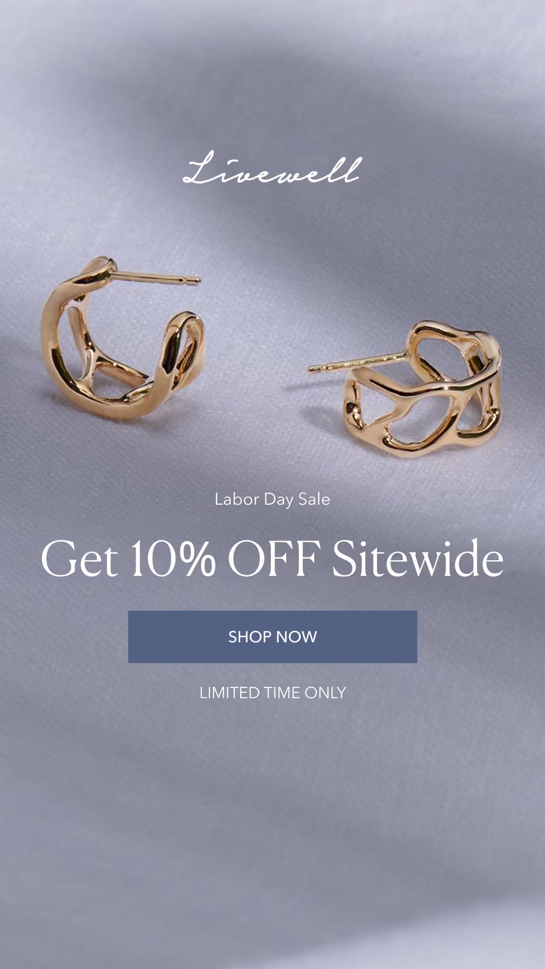 Gold hoop earrings on fabric background in a Labor Day sale banner ad.