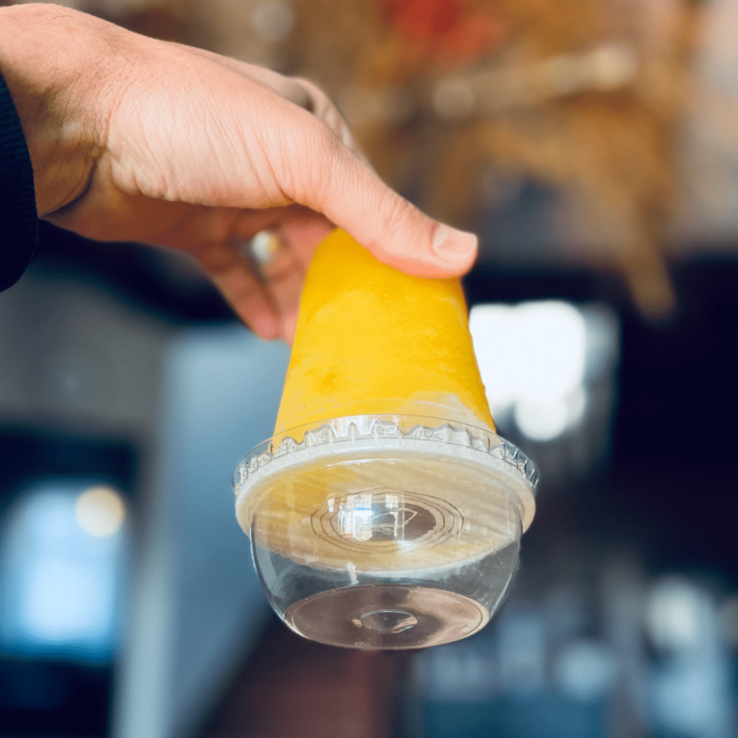 person holding cup upside down