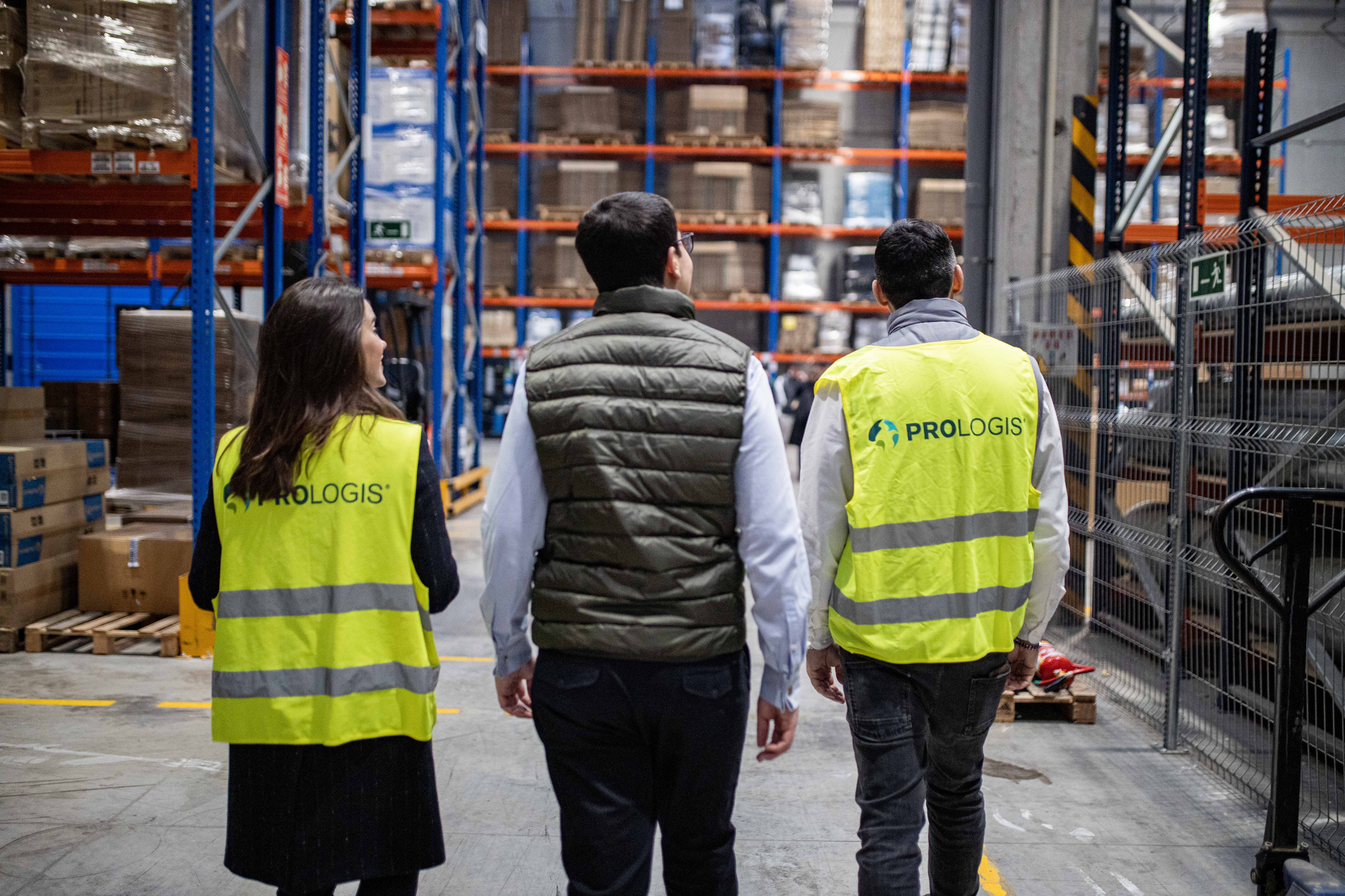 3 people walking in a Prologis warehouse