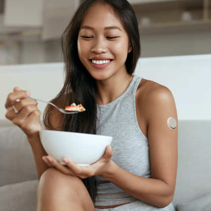 Woman with continuous glucose monitor eating